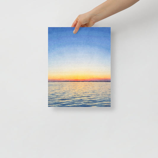 A Horizon on Fire sunset art print featuring bold reds and oranges in Hilton Head coastal landscape, displayed in a beach-inspired living room.